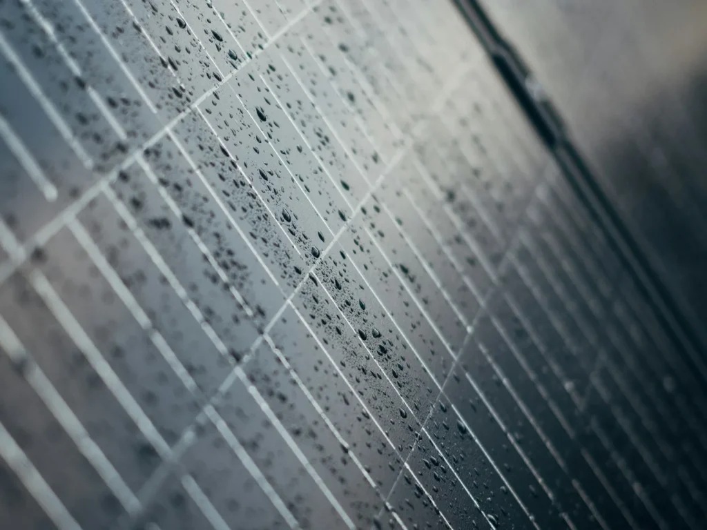 Close-up of a solar panel surface with dust and water marks