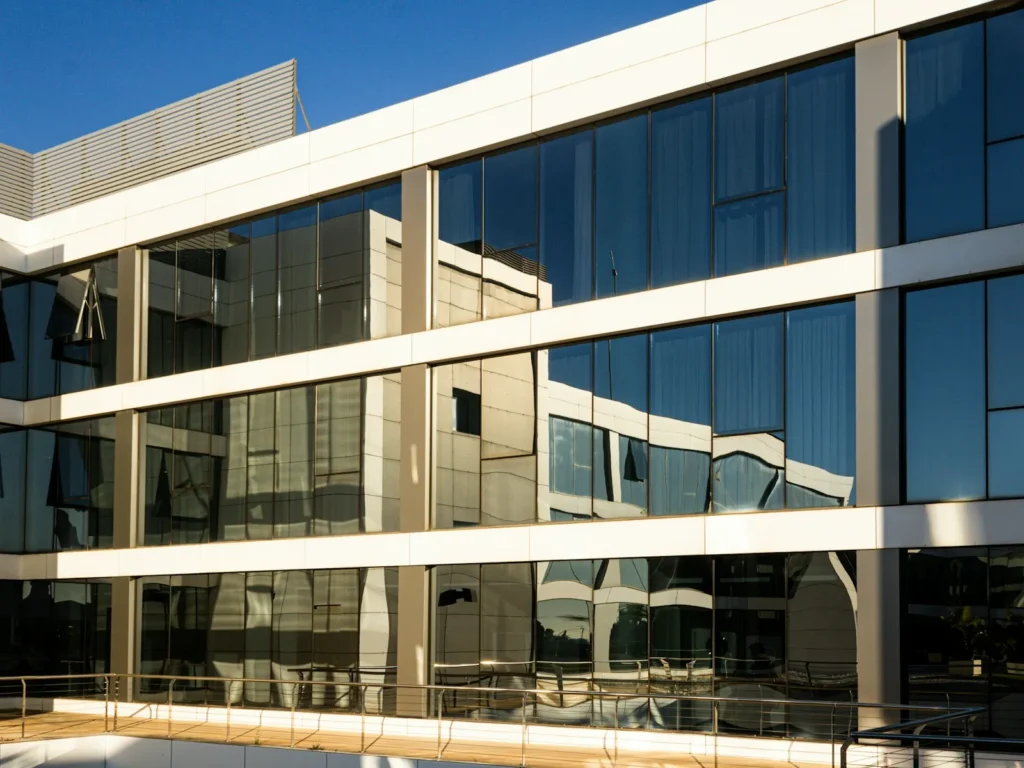 Office building with rows of reflective glass windows