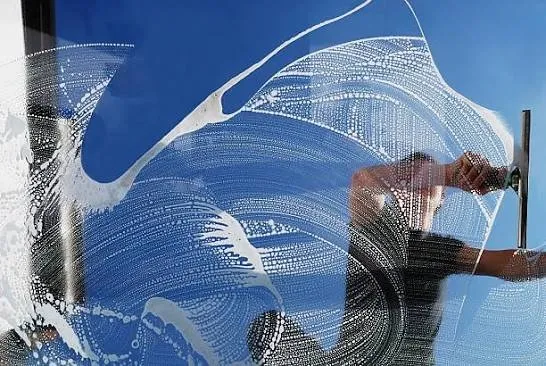 Soap swirl pattern on glass during window washing in Temecula