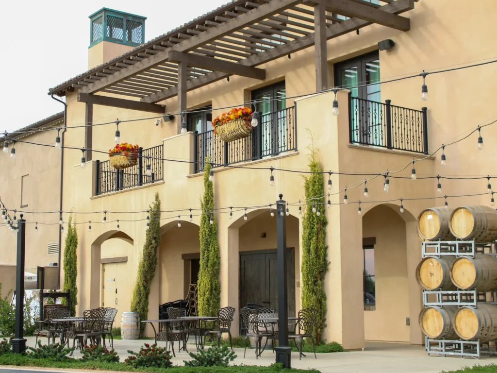 Mediterranean-style tasting room with arched windows and patio lights