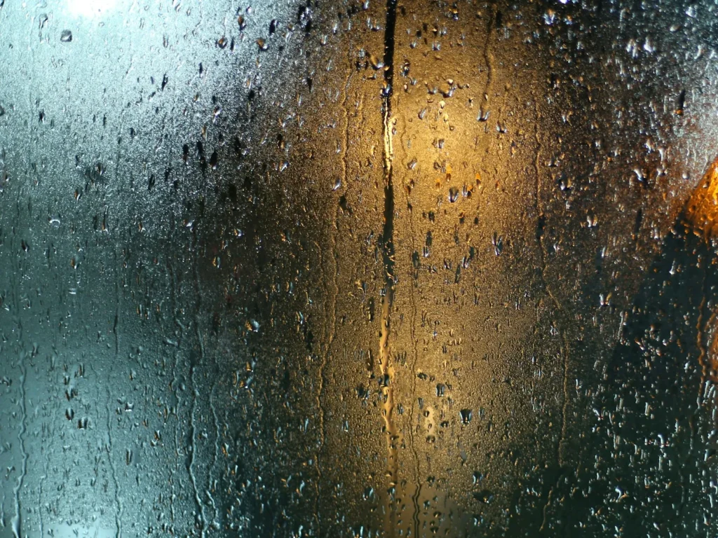 Close-up of water spots and droplets dried on window glass